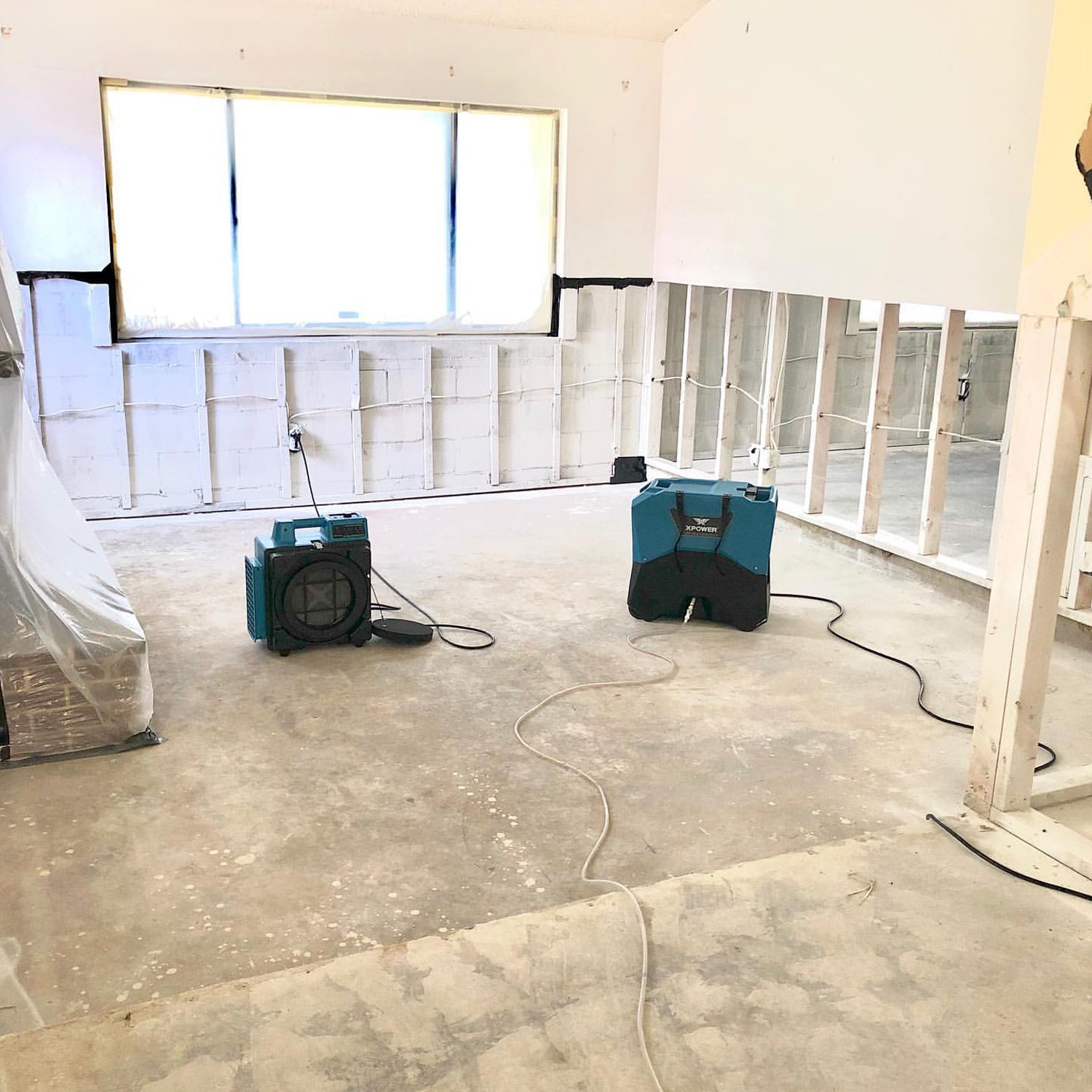 XPOWER X-2480A Professional 3-Stage HEPA Mini Air Scrubber filtering air on a job site
