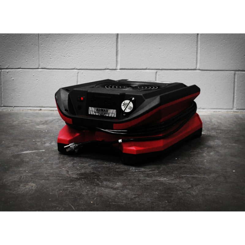 view of Phoenix AirMAX BLE Bluetooth Enabled Low Profile Radial Air Mover in red in a warehouse type background