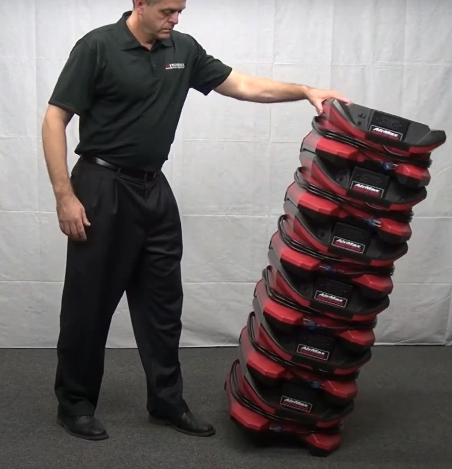 shows a man tilting a stack of red Phoenix AirMAX Radial Air Moverx