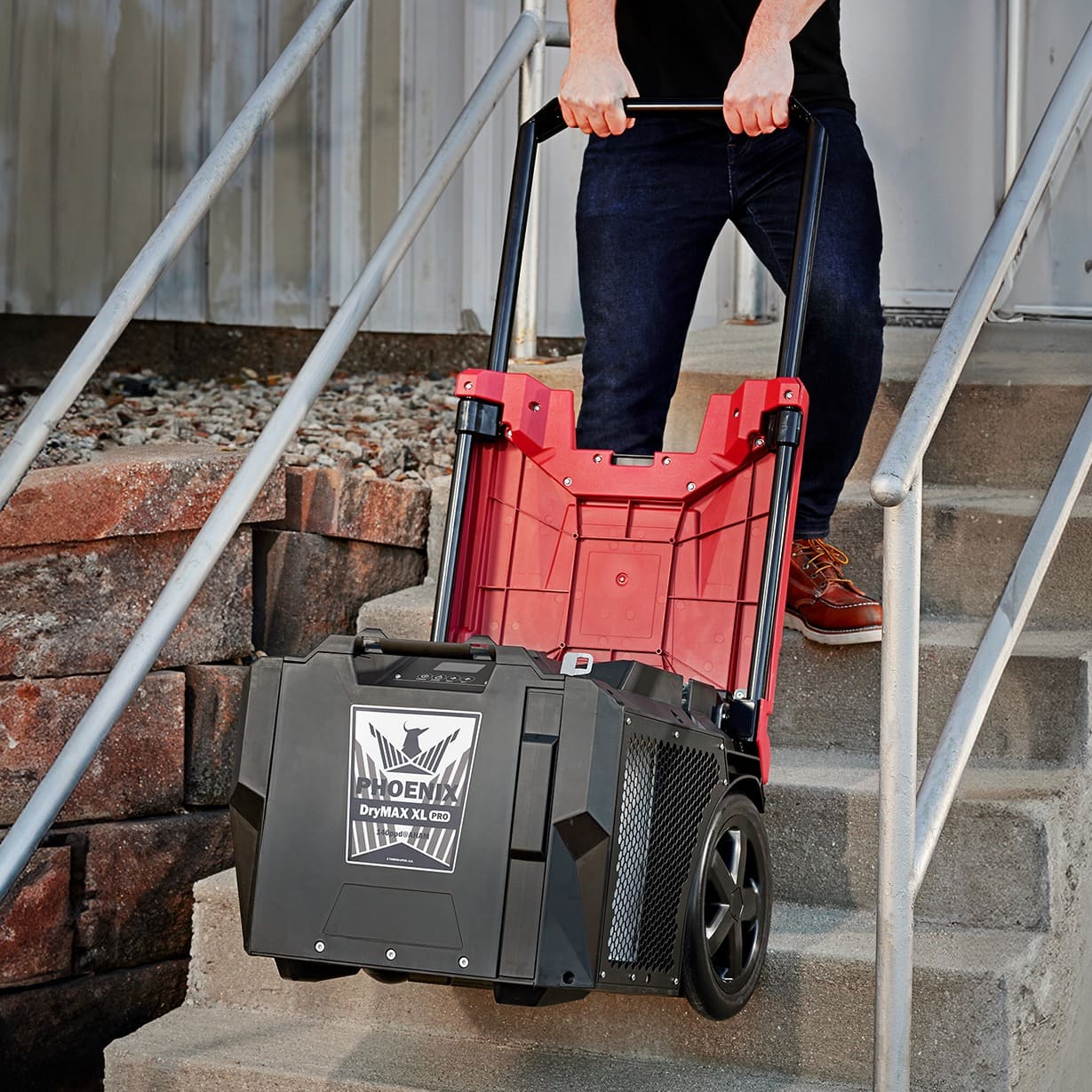 view of Phoenix DryMAX XL Pro LGR Dehumidifier in red going up the stairs
