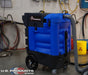 view of a blue US PRODUCTS Kraken Flood Pumper Extractor - 25' Vacuum Hose & 50' Dump Hose Bundle being used in a warehouse