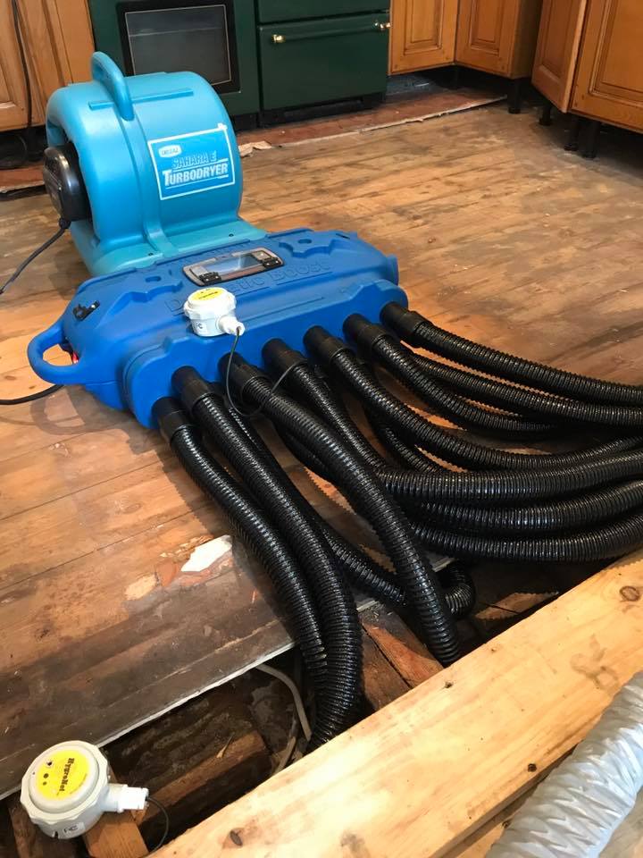 DBK DRYMATIC - Floor & Wall Heat Drying System, #FGPH109, Boost Bar with 12 black drying hoses hooked up drying a subfloor area