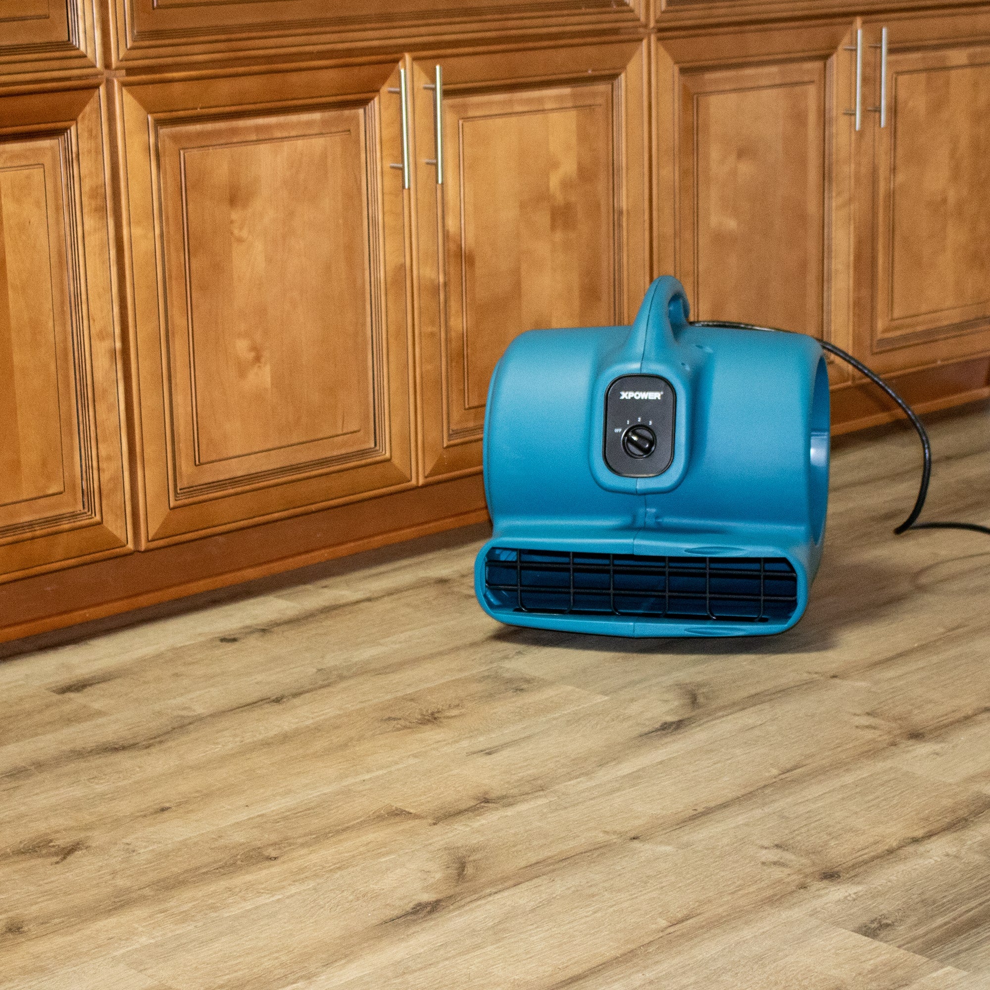 xpower x 600a in blue drying out a kitchen wooden floor
