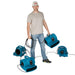 man carrying a blue xpower x 400a and 3 other units are daisy chained on the floor around him