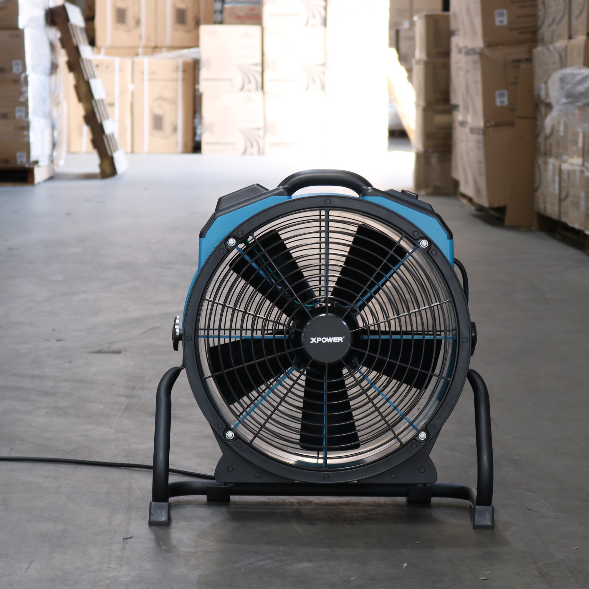 a blue xpower x 47atr axial fan in a warehouse