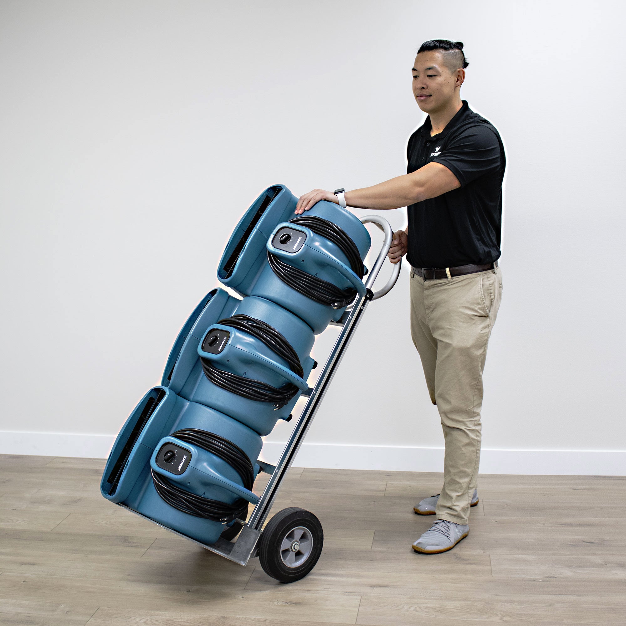 XPOWER P-630 1/2 HP 3 Speed Air Mover, Carpet Dryer, Floor Fan, Blower - 2980 CFM  being moved with dolly
